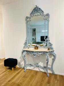 a dressing table with a mirror on top of it at Domus Lucia in Syracuse