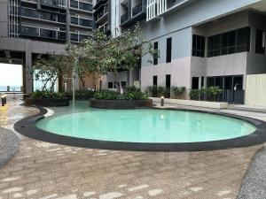 a swimming pool in the middle of a building at Imperio Residence Malacca By Al Abraar in Melaka