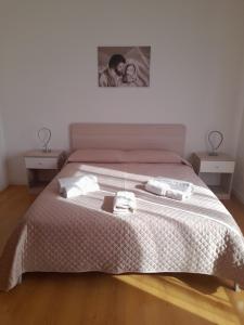 a bedroom with a bed with two towels on it at Dolce dormire in Fulgatore +13 photos