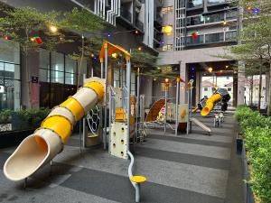 a playground in a building with yellow and white rockets at Imperio Residence Malacca By Al Abraar in Melaka
