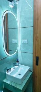 a bathroom with a white sink and a mirror at Deep Palace Inn in Mathura +13 photos