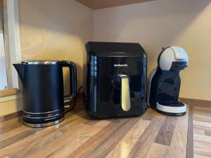 a coffeemaker and a coffee maker sitting on the floor at Caravan 5 by The River Severn, dog friendly, great for contractors, walkers and fishing on the river in Chaceley