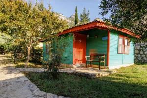 a green and red house with a red door at Green Forest in Kas