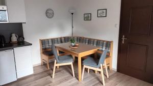 a dining room table with two chairs and a table at Haus Linn in Ehrwald