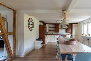 a kitchen and dining room with a table and a dartboard on the wall at Vakantiehuis Siedling in Winterberg