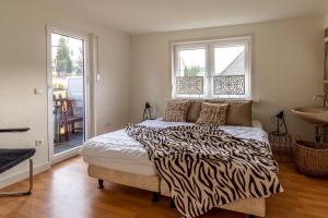 a bedroom with a bed with a zebra print blanket at Vakantiehuis Siedling in Winterberg