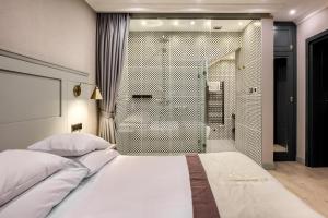 a bedroom with a large bed and a shower at Krupówki 17 Boutique Residence in Zakopane +98 photos