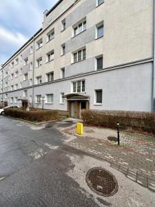 a large white building with a street in front of it at Śląska 33 in Gdynia