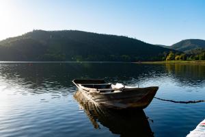 a boat sitting in the water on a lake at Canto do Zêzere, Sertã, Dornes, Castelo do Bode in Cernache do Bonjardim +19 photos