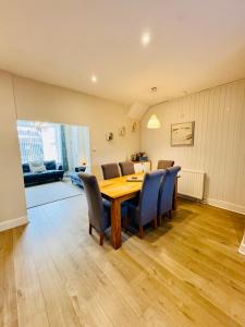 a dining room with a wooden table and chairs at HomeDecor Cottages - The Sands Cottage in Seahouses