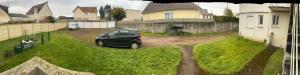 a car parked in the driveway of a house at Ouitreham le Port-de-Mer in Ouistreham