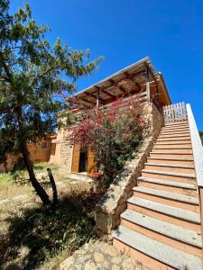 a set of stairs leading up to a house at Appartamento Baia Mimose in Badesi