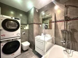 a bathroom with a toilet sink and a washing machine at Nyska Apartment - Self Check-In 20h - Parking & Lift in Wrocław +10 photos