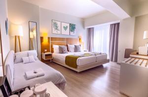 a hotel room with two beds and a mirror at St George Lycabettus Lifestyle Hotel in Athens