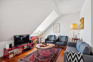 a living room with a couch and a tv at Apartment Near The Pedestrian Streets In Ebeltoft in Ebeltoft