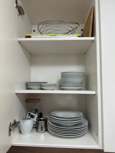 a cupboard filled with plates and dishes at Litus in Njivice +14 photos