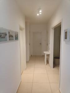 a hallway with white walls and a tile floor at Marin in Šibenik