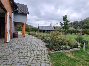 a brick walkway next to a house with a garden at ASKAHA Glamping in Oskava +7 photos