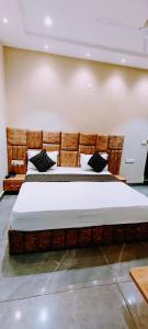 a bedroom with a large bed in a room at Hotel Orio Castle in Ludhiana