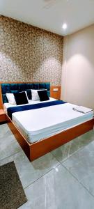 a bedroom with a large bed in a room at Hotel Orio Castle in Ludhiana