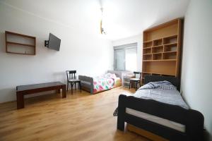 a bedroom with a bed and a table and a desk at Casa & Spa Medison in Zrenjanin +31 photos