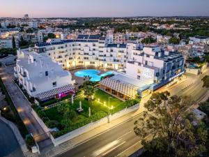 an aerial view of a city at night at Santa Eulalia Hotel & Spa in Albufeira