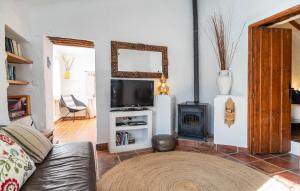 a living room with a couch and a stove at Casa La Casita in Periana