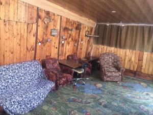 a living room with two chairs and a table at holiday house in Yerevan