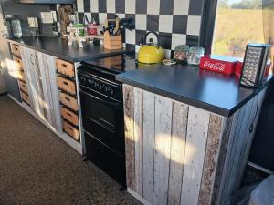 a kitchen with a black counter top and a stove at Topdeck double decker bus in Swellendam