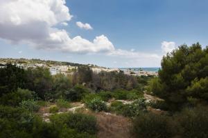 a view of a city from a hill with trees at Casa del sole pp by Salento prime in Marina di Pescoluse