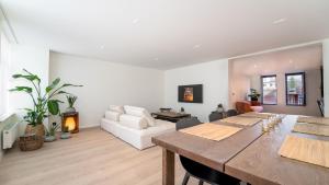 a living room with a table and a couch at ZILTer - Groot duplex appartement met terras in Ostend