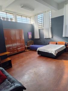 a bedroom with a bed and a couch at Casa loft Internet 500Mb in Sao Paulo +27 photos