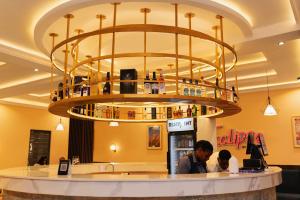 a large chandelier above a counter in a store at The Manor Hotel by Luckzi in Owerri