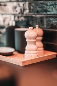 two clay chess pieces sitting on a wooden shelf at ZILTer - Groot duplex appartement met terras in Ostend