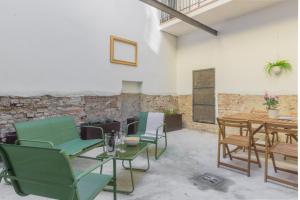 a room with chairs and a table and a table and chairs at Residence Croce in Piacenza