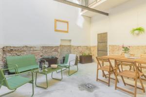 a room with a table and chairs and a brick wall at Residence Croce in Piacenza +7 photos