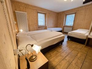 Postel nebo postele na pokoji v ubytování Albergo Al Pin