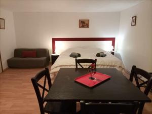 a room with a bed and a table with a table sidx sidx sidx at La Baronnerie in Saint-Marc-dʼOuilly