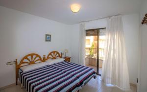 A bed or beds in a room at Primera línea Playa Cargador - Playamar 1021 - ALBERT VILLAS