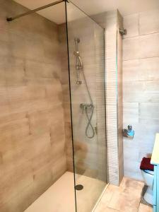 a shower with a glass door in a bathroom at Spacious Holiday Apartment nearby Arenal Javea in Jávea +19 photos