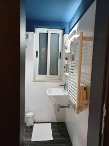 a small bathroom with a sink and a window at Nemy Sliema Guesthouse in Sliema +22 photos