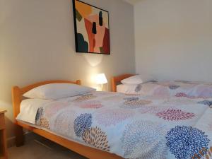 a bedroom with two beds and a painting on the wall at Villa Tominčići By Istrialux in Pićan +18 photos