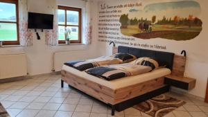 a bed in a room with a poster on the wall at Campingplatz Jurahöhe in Pottenstein