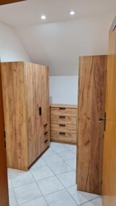 a room with two wooden doors and a white tile floor at Campingplatz Jurahöhe in Pottenstein +5 photos