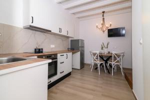 a kitchen with a table and a dining room at Kiki House in Rhodes Town