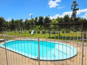 a small pool with a fence around it at Chacra Don Joaquin 2 in La Cruz