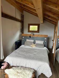 een slaapkamer met een groot bed met een blauw hoofdeinde bij Le chalet Leïla in Manigod