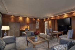 a living room with a couch and a table at Maritim Hotel Bellevue Kiel in Kiel