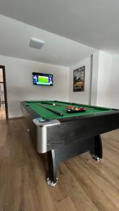 a billiard table in a living room with a pool at Domeniul H in Rişca