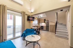 a living room with a table and a kitchen at Rigel Apartments 4 in Ioannina
